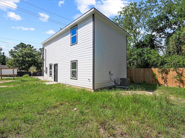 view of home's exterior featuring a yard and central AC