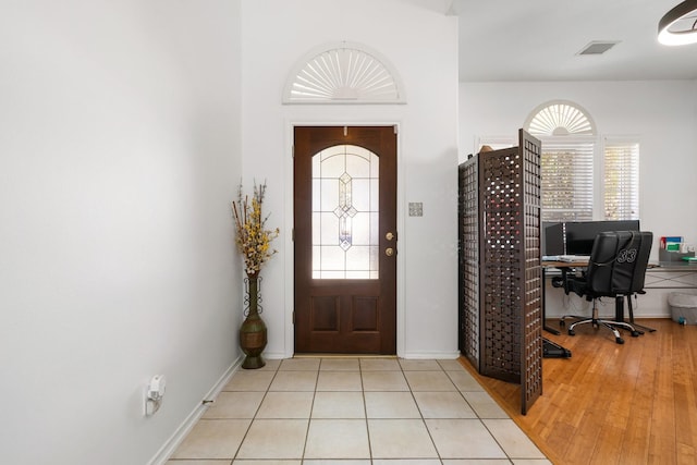 foyer featuring a wealth of natural light and light hardwood / wood-style floors