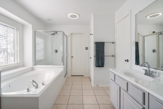 bathroom featuring tile patterned flooring, vanity, and separate shower and tub