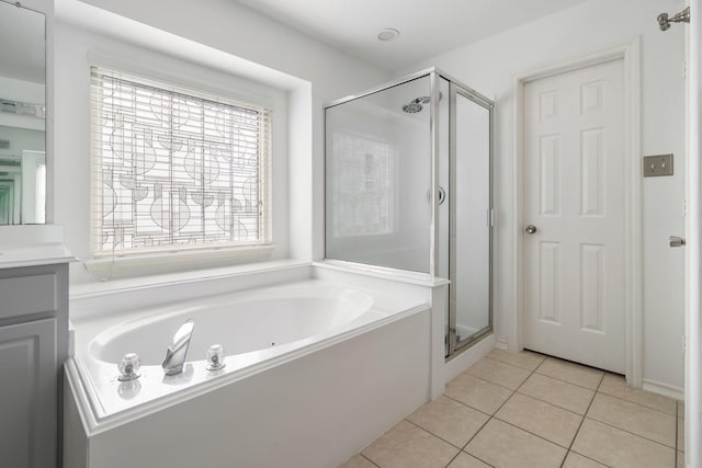 bathroom featuring tile patterned flooring, vanity, and shower with separate bathtub