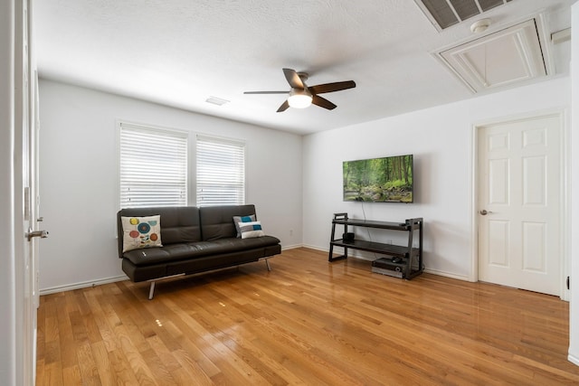 living room featuring ceiling fan and hardwood / wood-style floors