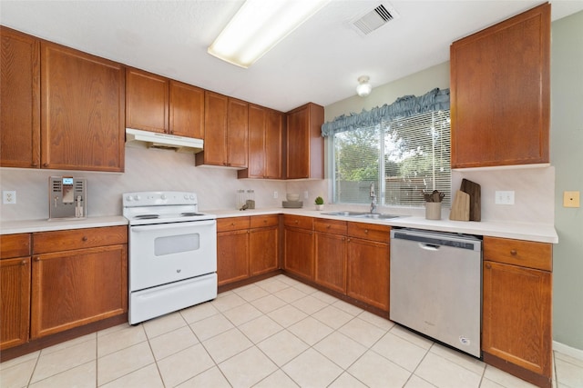 kitchen featuring light tile patterned flooring, sink, stainless steel dishwasher, and electric range