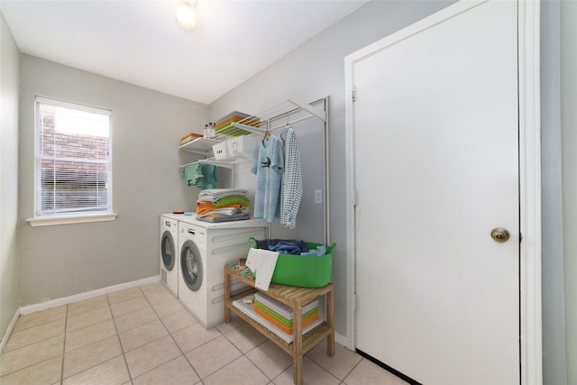 clothes washing area with light tile patterned flooring and independent washer and dryer