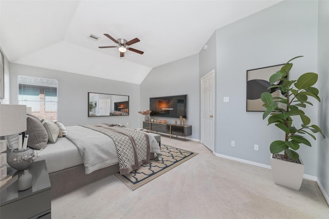 bedroom with light carpet, vaulted ceiling, and ceiling fan