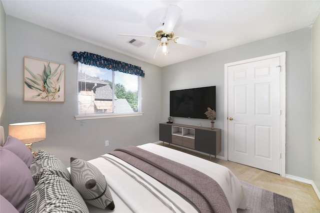 bedroom with ceiling fan and light colored carpet