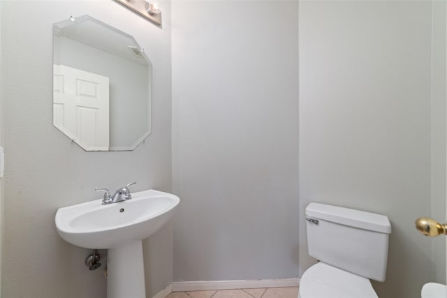 bathroom with tile patterned floors and toilet