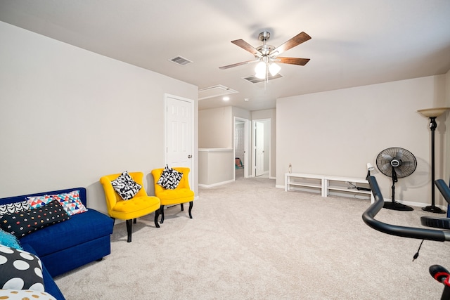 living area with light carpet and ceiling fan