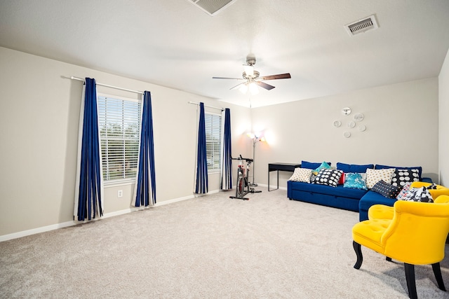 living room featuring ceiling fan and carpet flooring