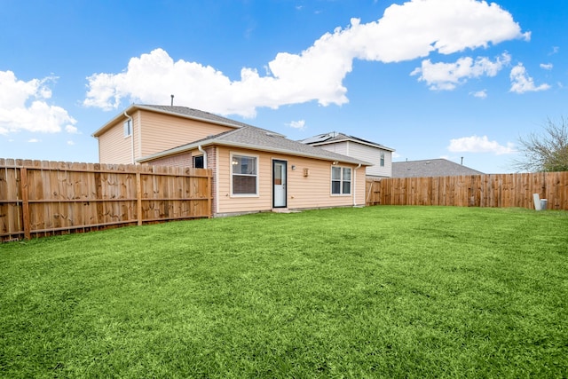 back of property featuring a lawn