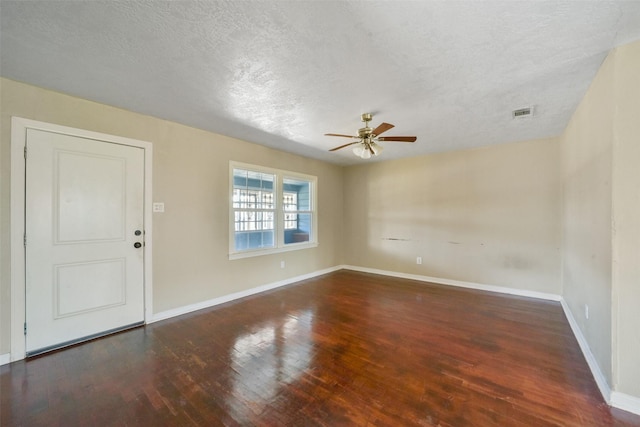 spare room featuring a textured ceiling, dark hardwood / wood-style floors, and ceiling fan