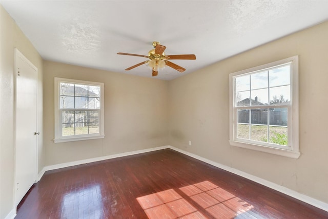 spare room with dark wood-type flooring, ceiling fan, and a textured ceiling