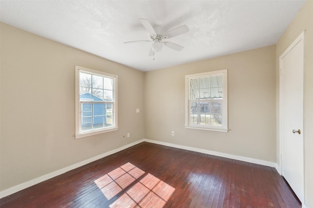 empty room with dark wood-type flooring, ceiling fan, and a textured ceiling