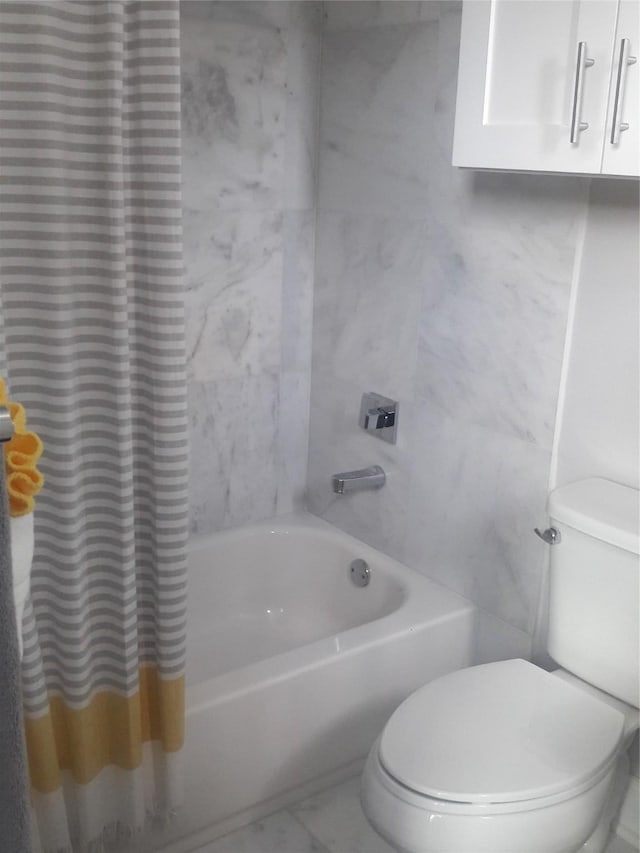 bathroom with shower / tub combo and toilet