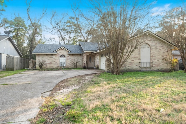 ranch-style home featuring a garage and a front yard