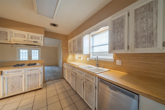 kitchen with sink, light tile patterned floors, tasteful backsplash, gas stovetop, and stainless steel dishwasher