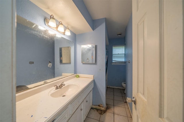 bathroom with vanity, tile patterned floors, and toilet