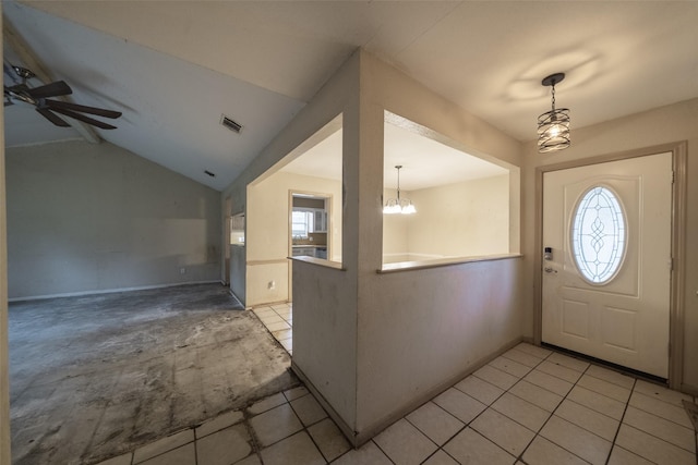 foyer with lofted ceiling, plenty of natural light, ceiling fan with notable chandelier, and light tile patterned floors