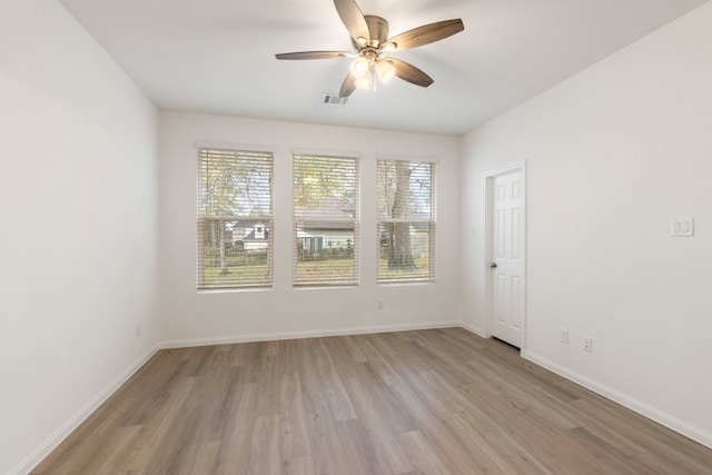 empty room featuring ceiling fan and light wood-type flooring