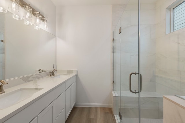 bathroom featuring vanity, hardwood / wood-style floors, and walk in shower