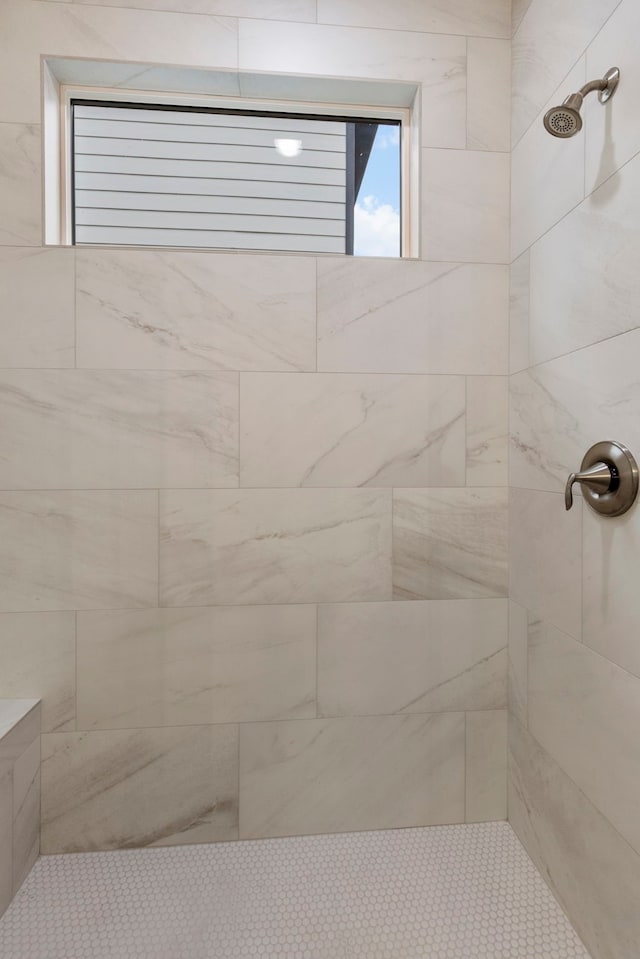 bathroom featuring a tile shower