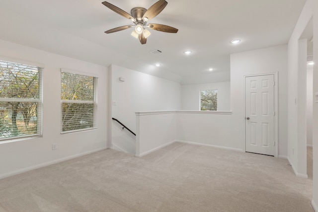 carpeted spare room featuring a healthy amount of sunlight