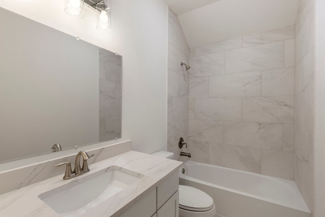 full bathroom featuring tiled shower / bath, vanity, and toilet