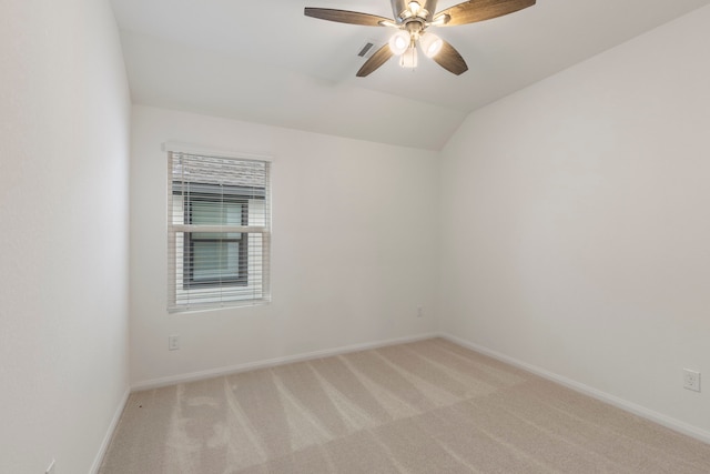 carpeted empty room with vaulted ceiling and ceiling fan