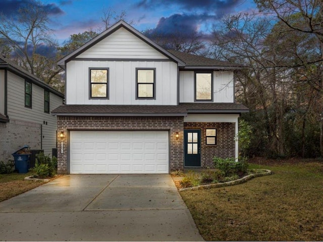 view of front of house with a garage and a lawn