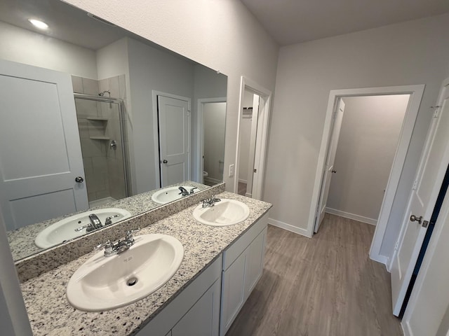 bathroom with vanity, wood-type flooring, toilet, and walk in shower