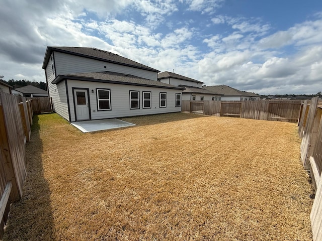 back of property featuring a yard and a patio area