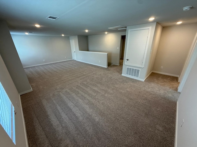 basement featuring light colored carpet