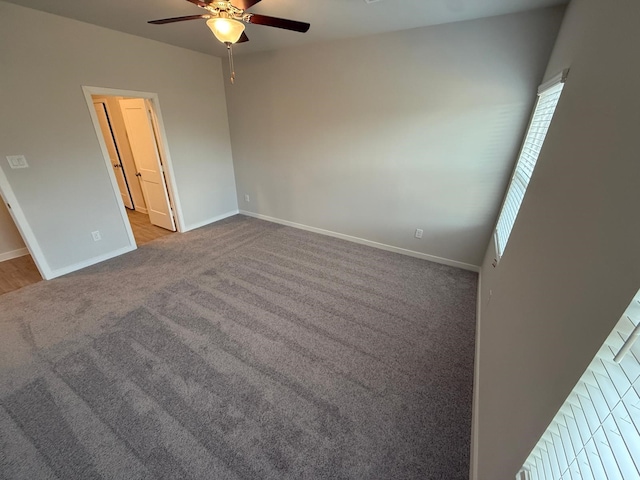 empty room featuring light colored carpet and ceiling fan