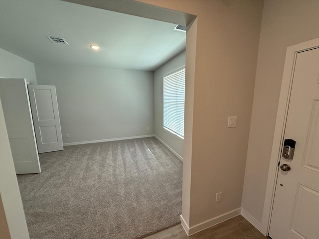 unfurnished room featuring carpet