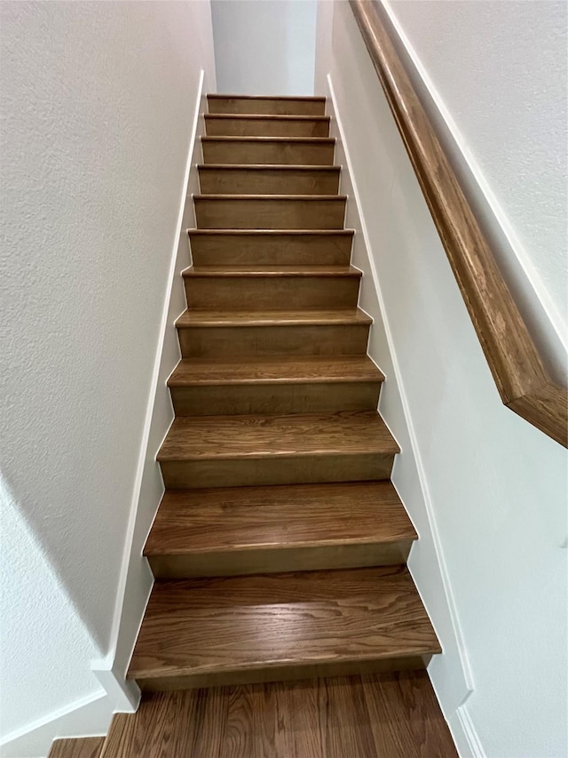 stairs with hardwood / wood-style flooring