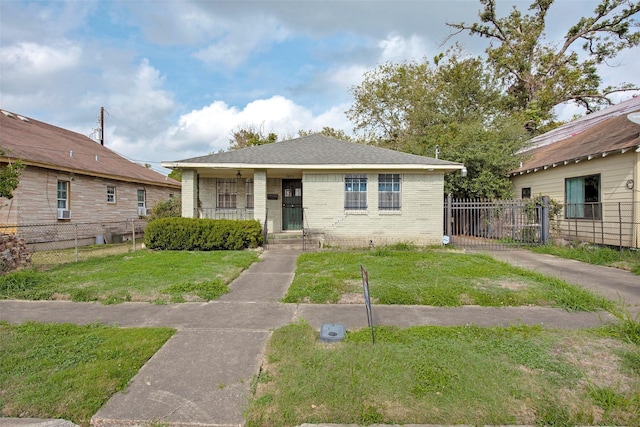 bungalow with covered porch and a front lawn