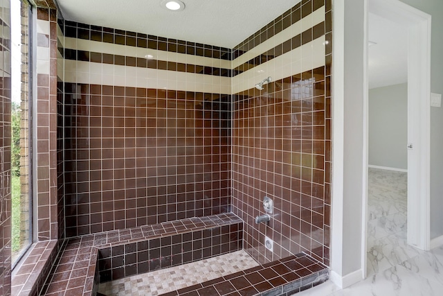 bathroom with a tile shower