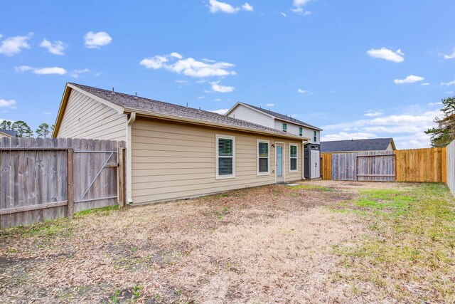 rear view of house with a yard