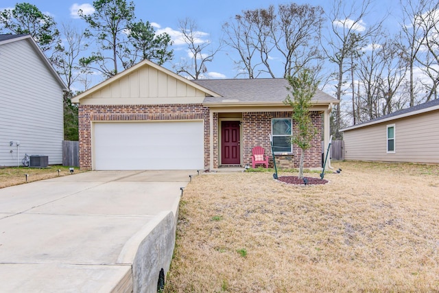 ranch-style house featuring central AC unit, a garage, and a front yard