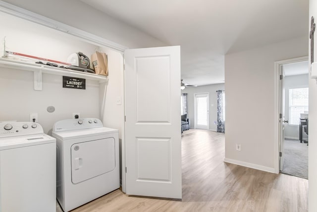 laundry room with light hardwood / wood-style flooring, washer and dryer, and ceiling fan