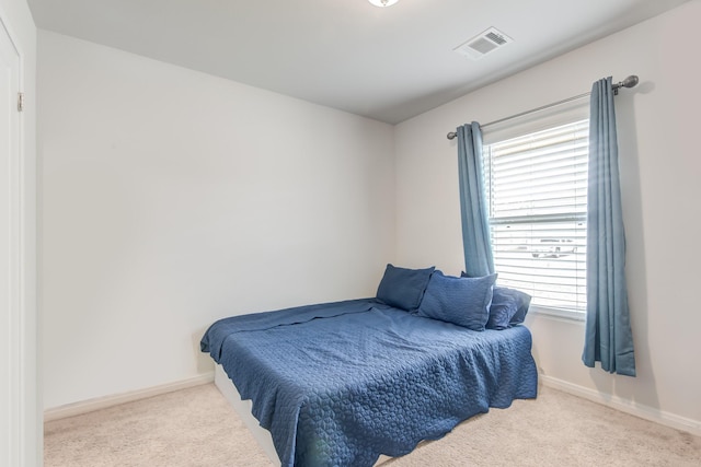 carpeted bedroom with multiple windows