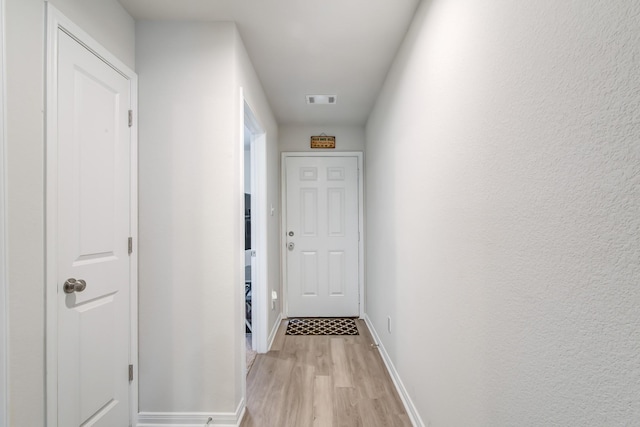 hall with light hardwood / wood-style flooring