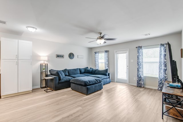 living room with light hardwood / wood-style floors and ceiling fan