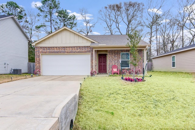 view of front of property with a garage, central AC, and a front lawn