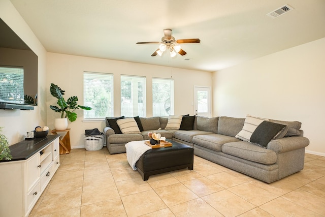 tiled living room featuring a wealth of natural light and ceiling fan