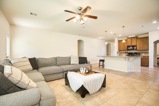 living room featuring ceiling fan and light tile patterned floors