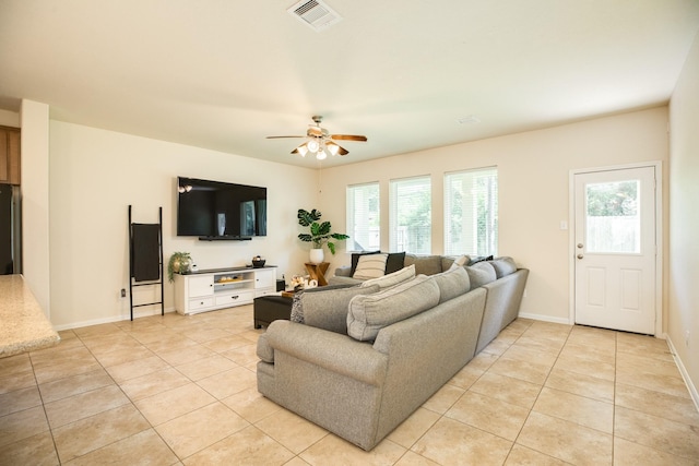 tiled living room with ceiling fan