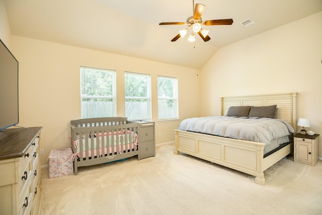 bedroom with lofted ceiling, light colored carpet, and ceiling fan