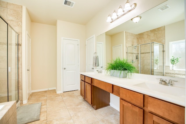 bathroom featuring vanity, tile patterned flooring, and a shower with shower door