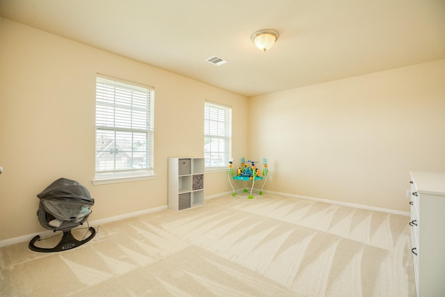 rec room with light colored carpet