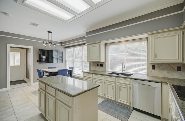 kitchen featuring a kitchen island, pendant lighting, dishwasher, sink, and cream cabinetry